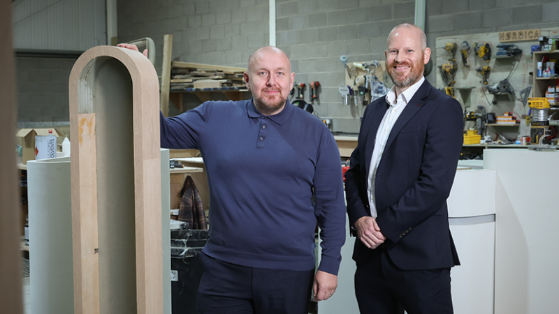 Two men standing in a interior architecture and design warehouse 